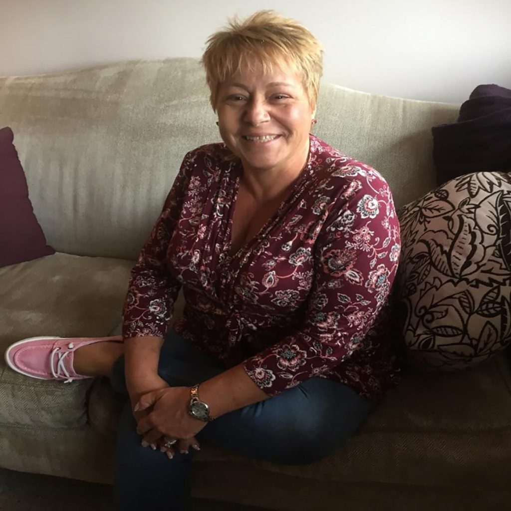 Paula sitting on a couch